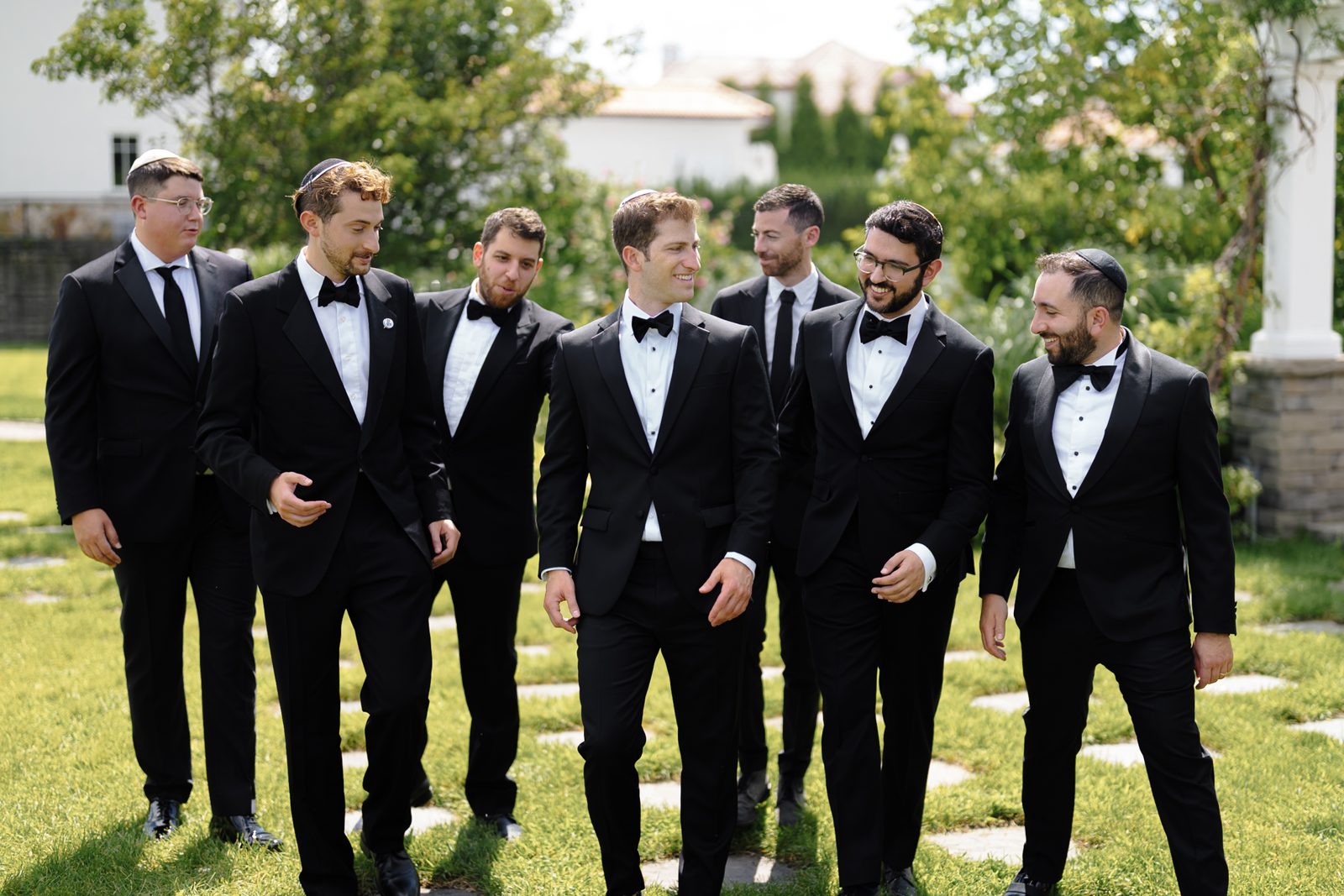 The groomsmen mid-laugh, in black and white