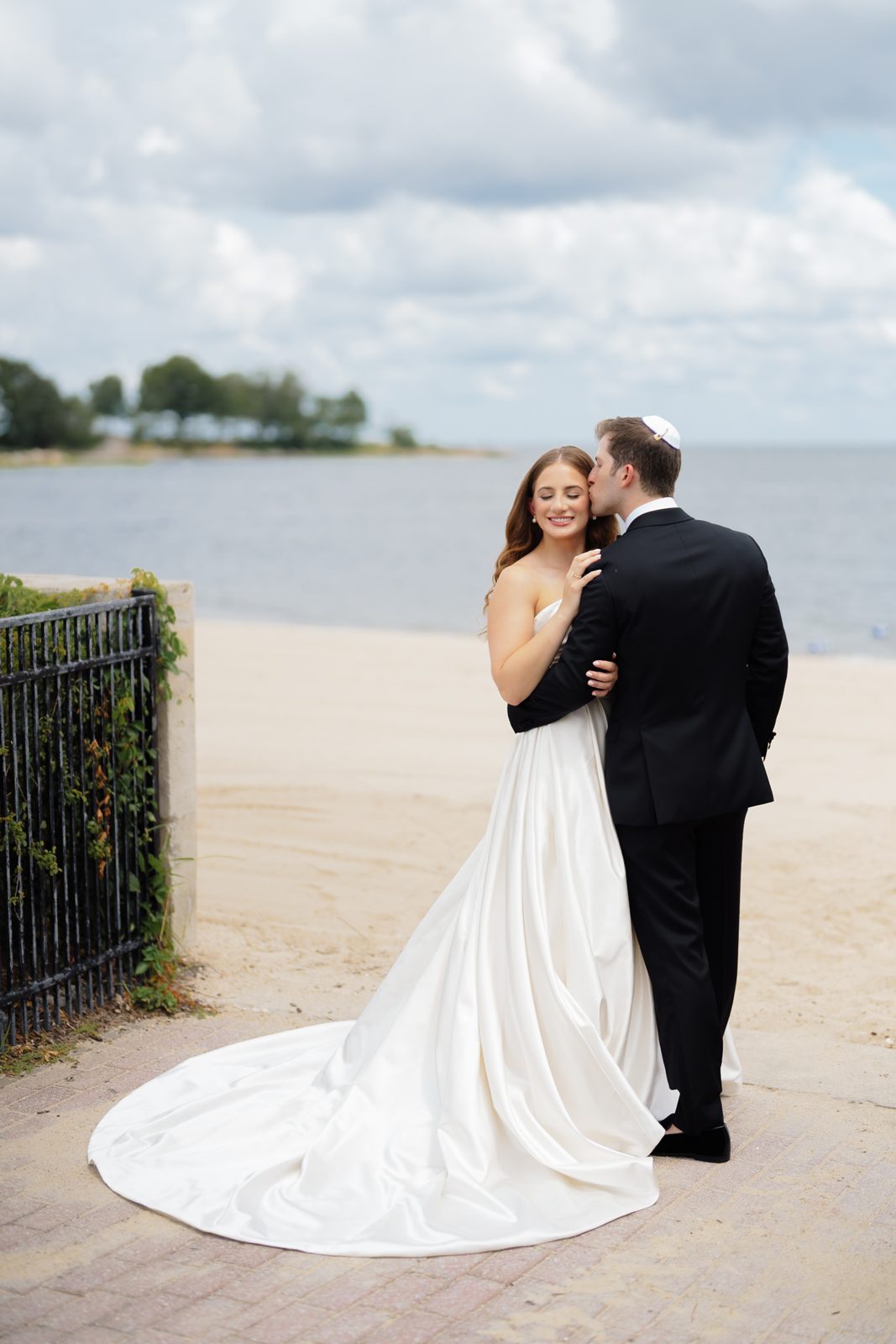 Bride and groom on the beach along Long Island Sound at Greentree Country Club, New Rochelle NY