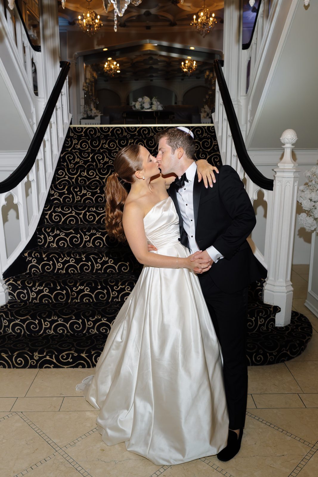 A kiss on the staircase at Greentree Country Club