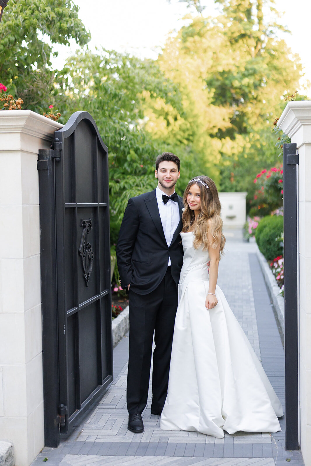 Noa and Nate at the estate gate in the evening light