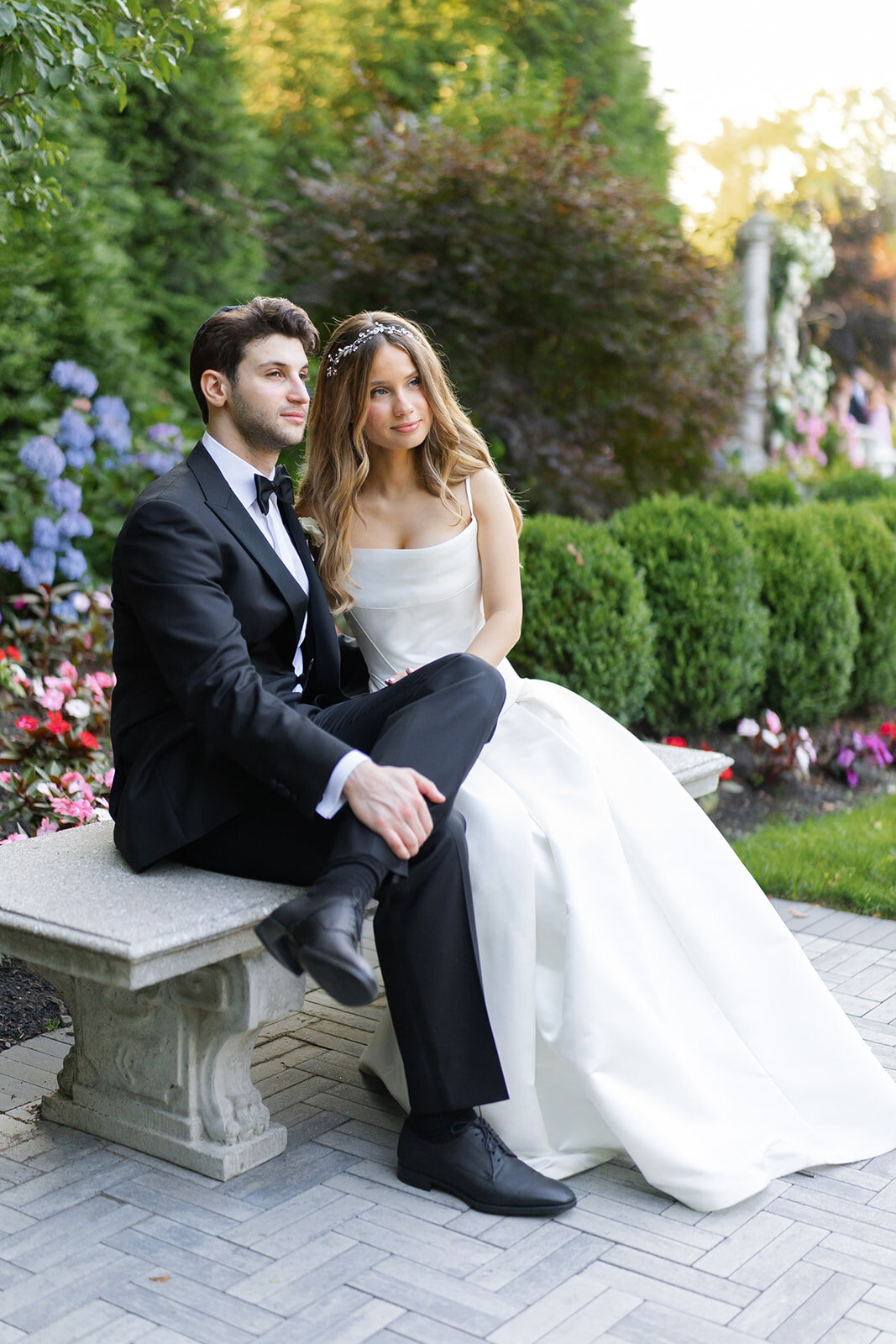 Noa and Nate on a stone garden bench at dusk