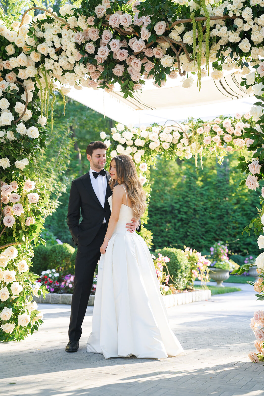 Noa and Nate under the rose-covered chuppah after the ceremony