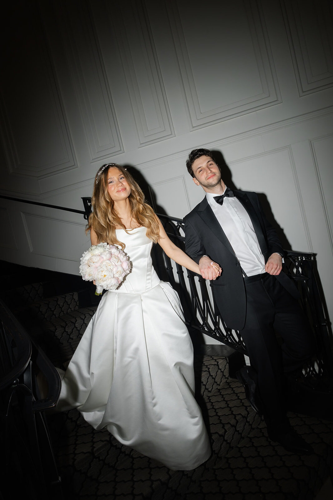 Black and white photo of Noa and Nate on the staircase
