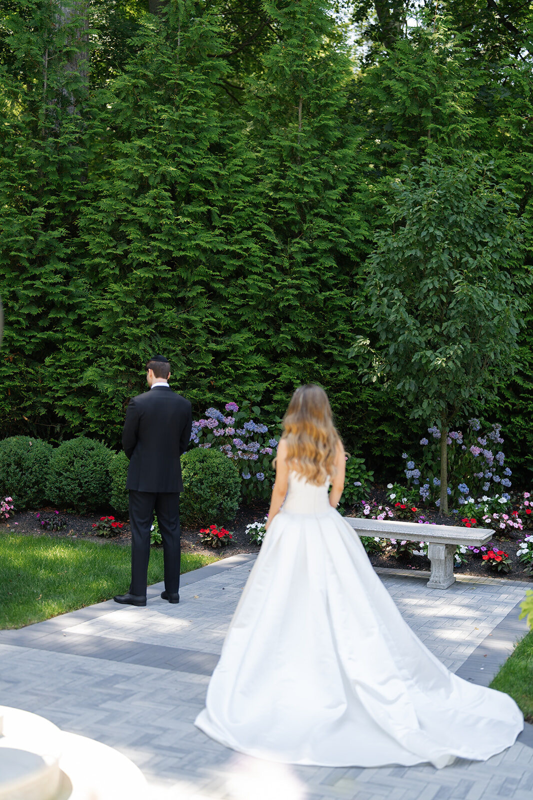 Noa walks up the garden path toward Nate for their first look
