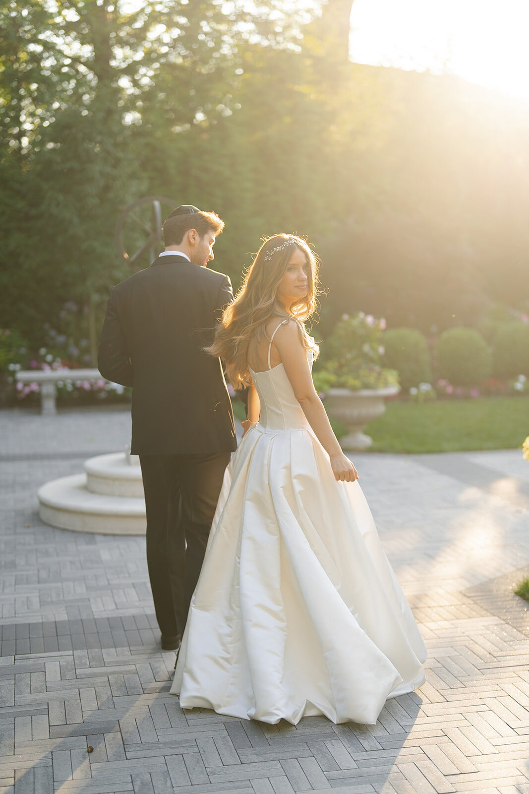 Golden hour in the gardens, the sun glowing behind Noa and Nate