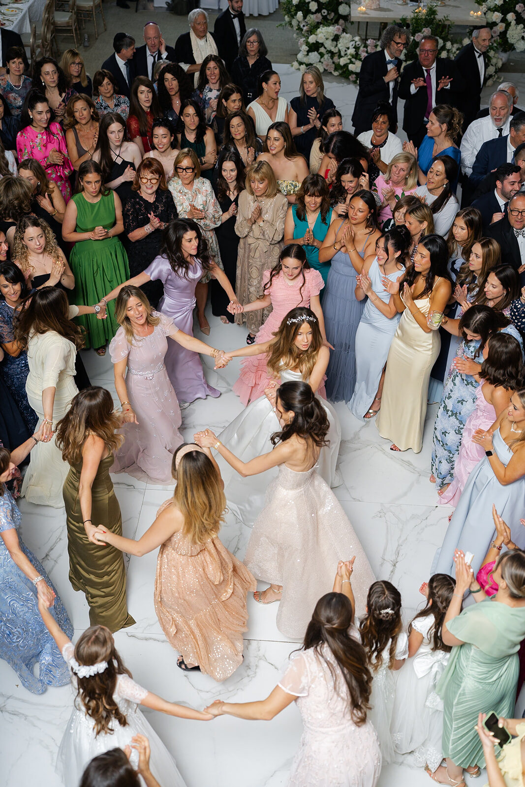 The hora seen from above, circles of guests dancing around Noa