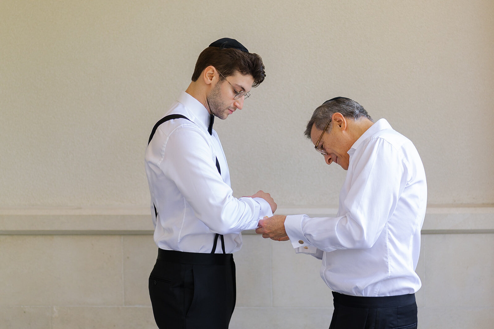 Nate’s father fastens his cufflinks as he gets ready