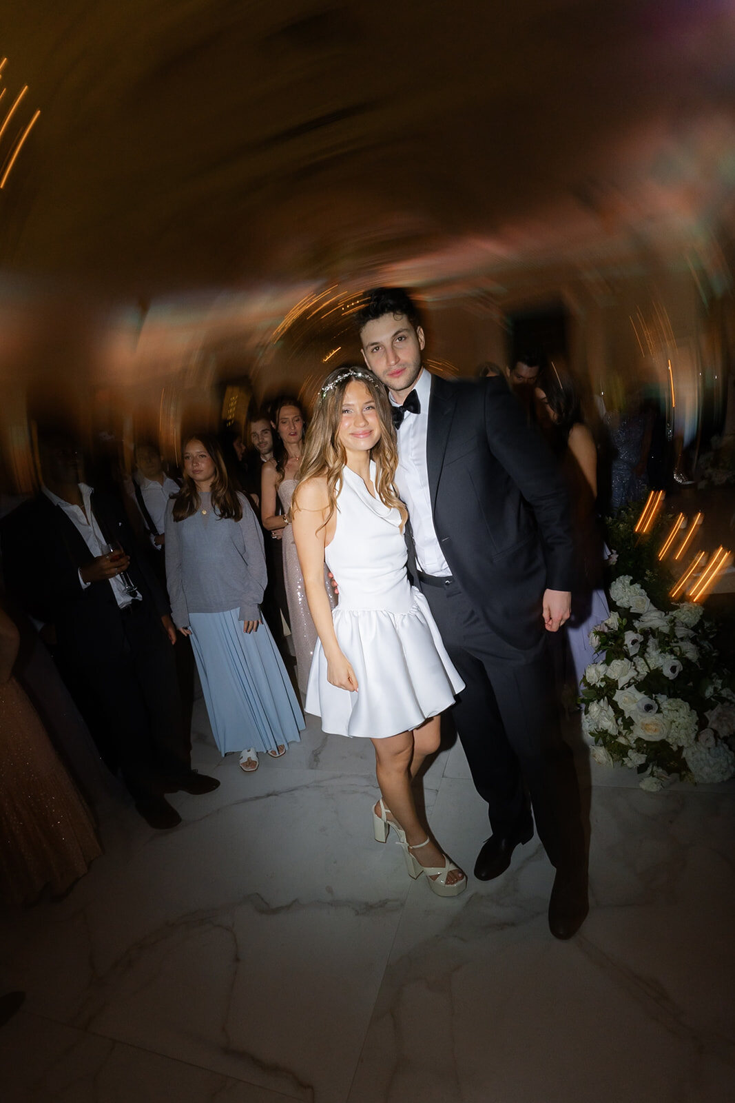 Noa in her short white second dress on the dance floor with Nate