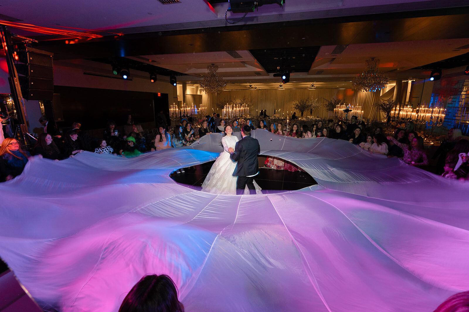 The ballroom dance floor at Old Westbury Hebrew Congregation washed in pink light during the first dance
