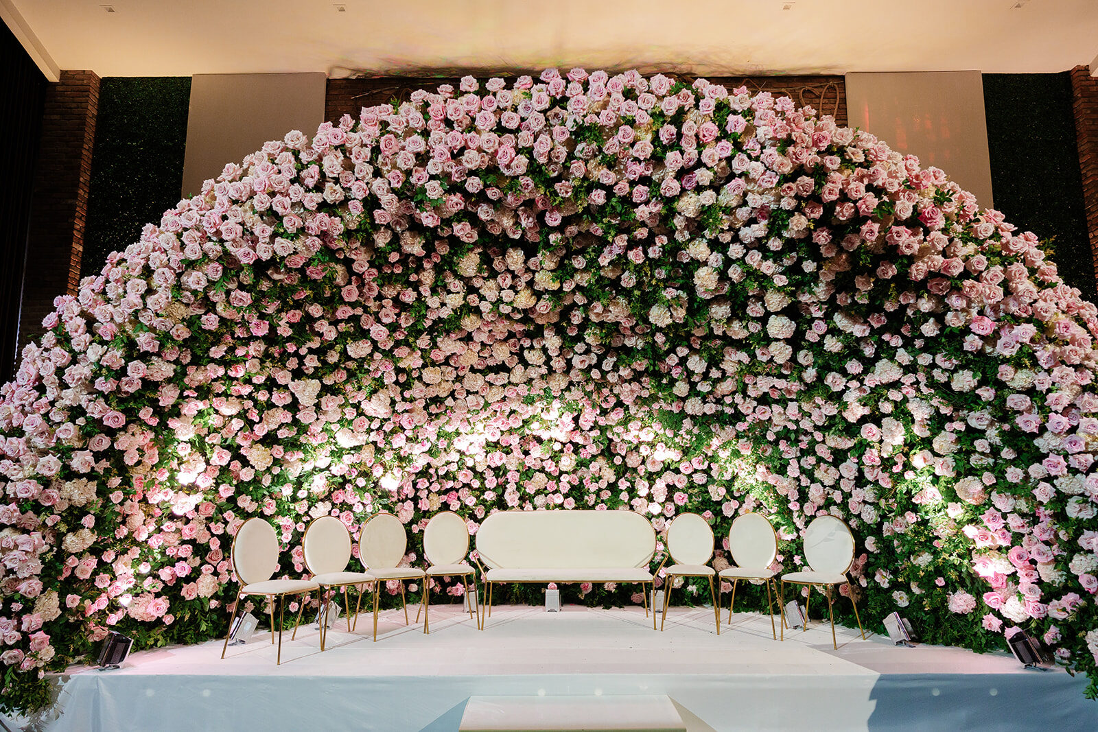 The reception at Old Westbury Hebrew Congregation set beneath a wall of pink and white roses