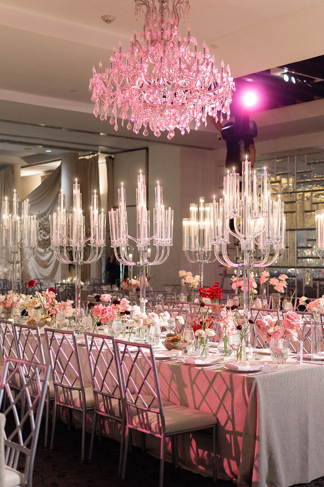 Reception table beneath a pink chandelier at Old Westbury Hebrew Congregation