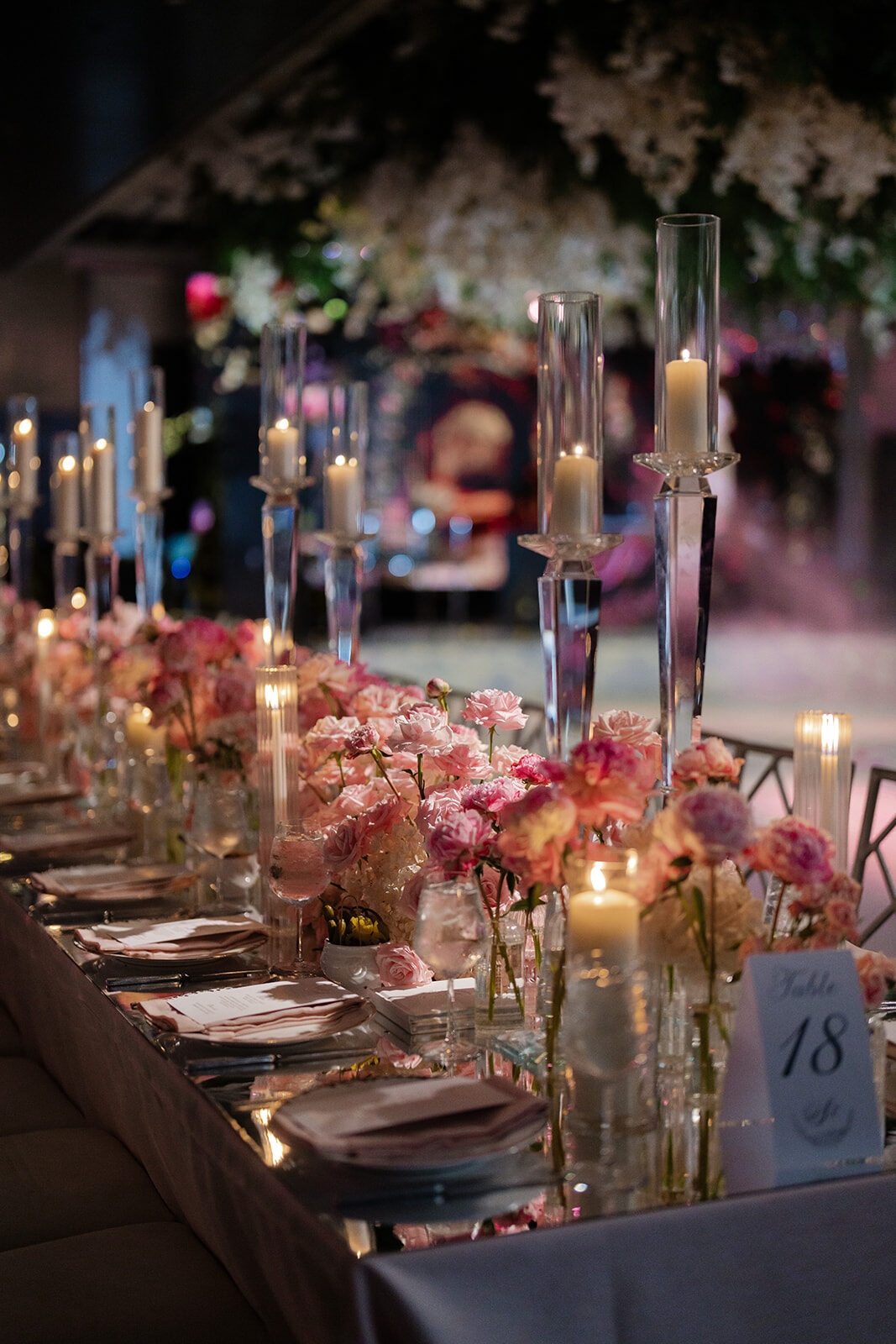 Candlelit reception tablescape with gold vessels and pink roses at Old Westbury Hebrew Congregation