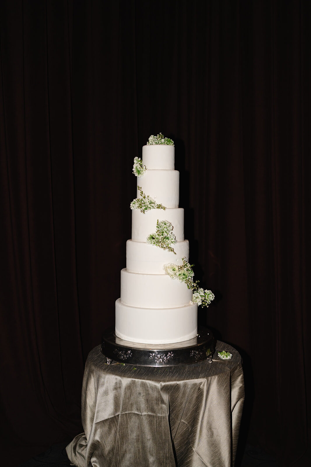 Rebecca and Joe's five-tier white wedding cake with greenery at Old Westbury Hebrew Congregation