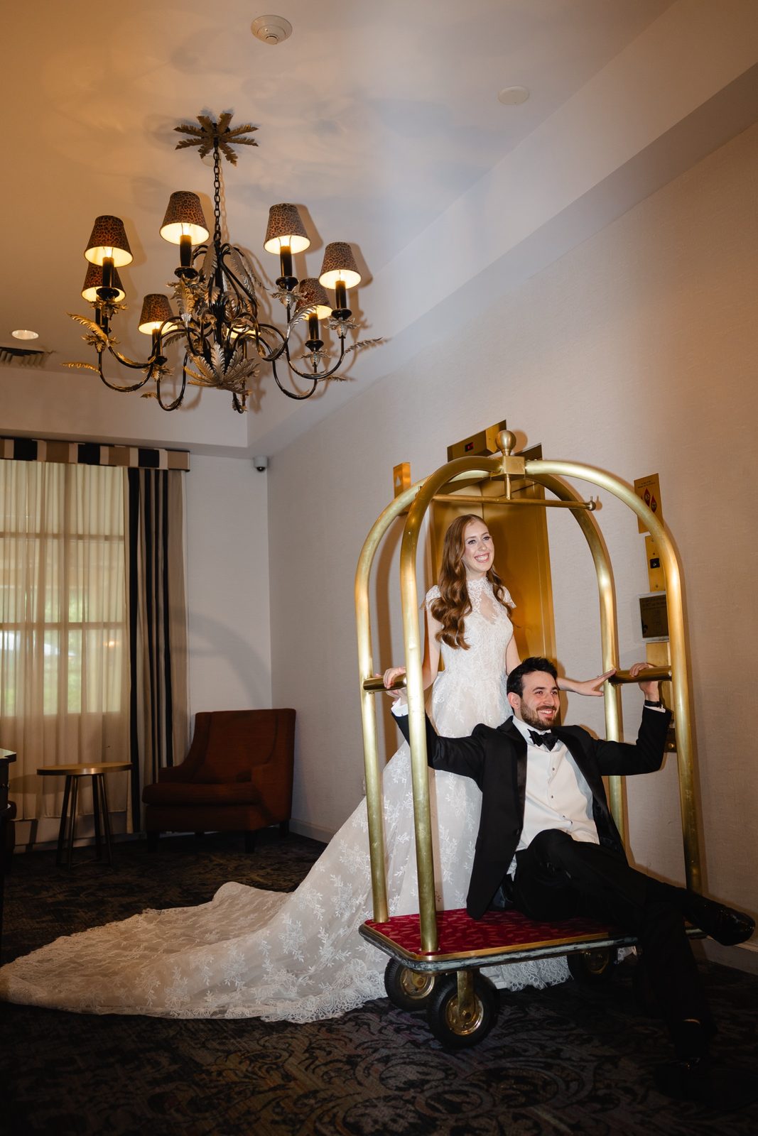Haley and Evan with the brass luggage cart in the lobby