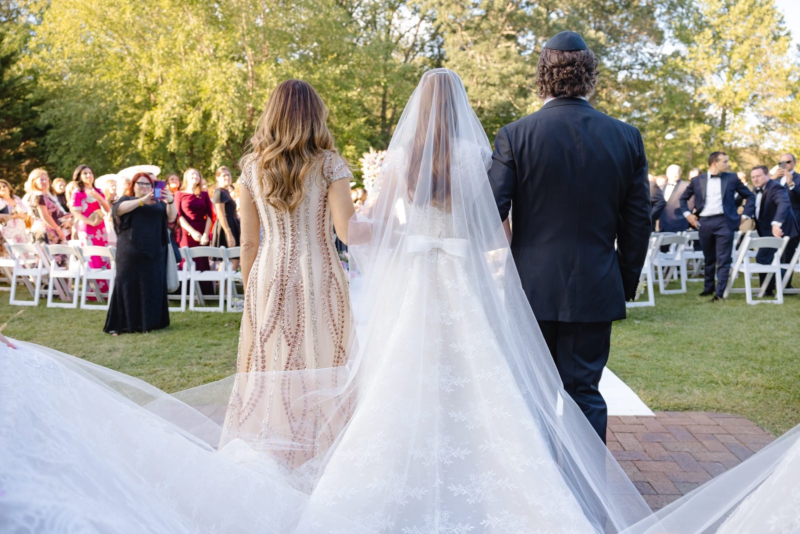 Haley walking down the aisle, her cathedral train behind her