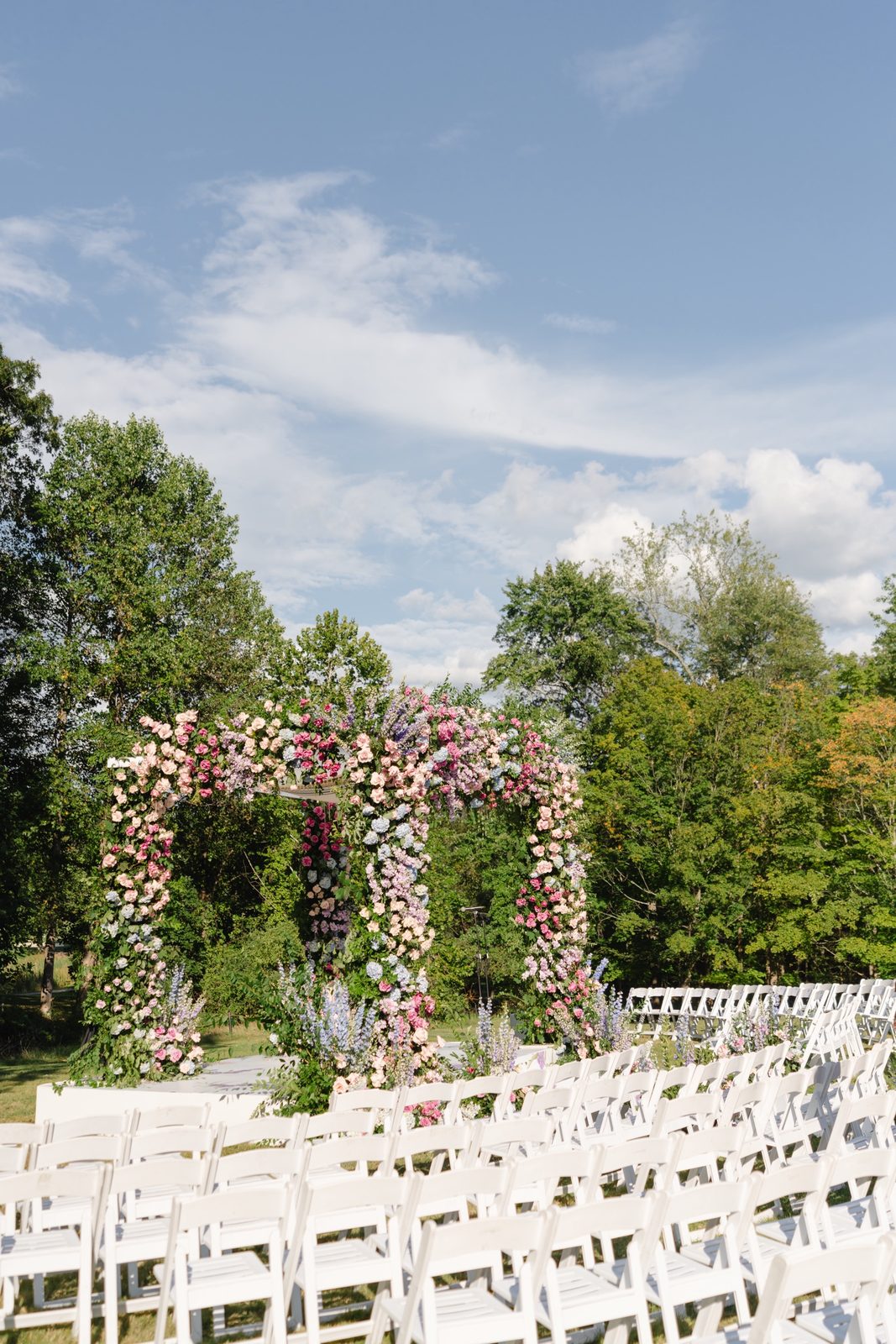 The floral chuppah against the sky on the lawn