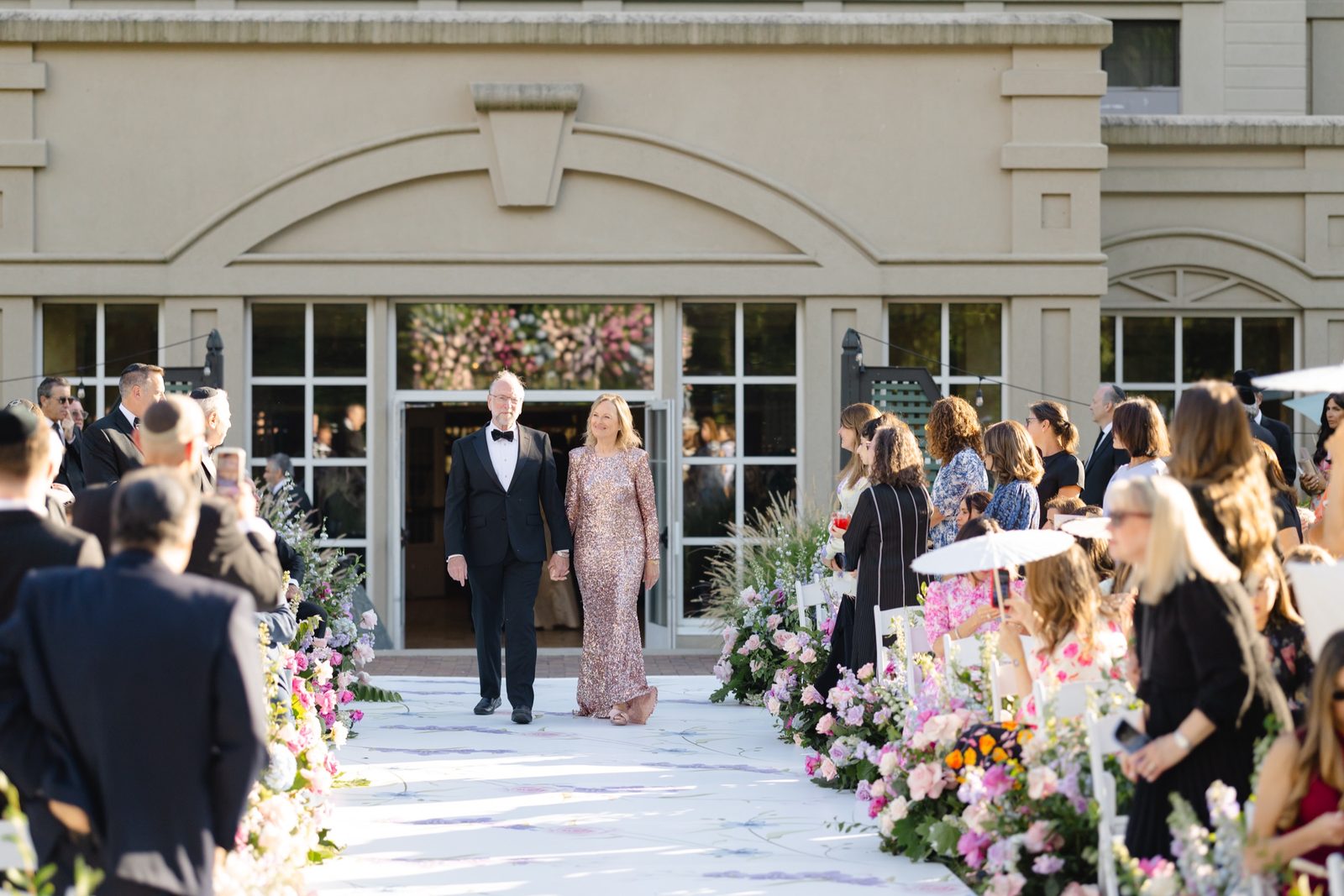 The processional walking out of the hotel onto the aisle