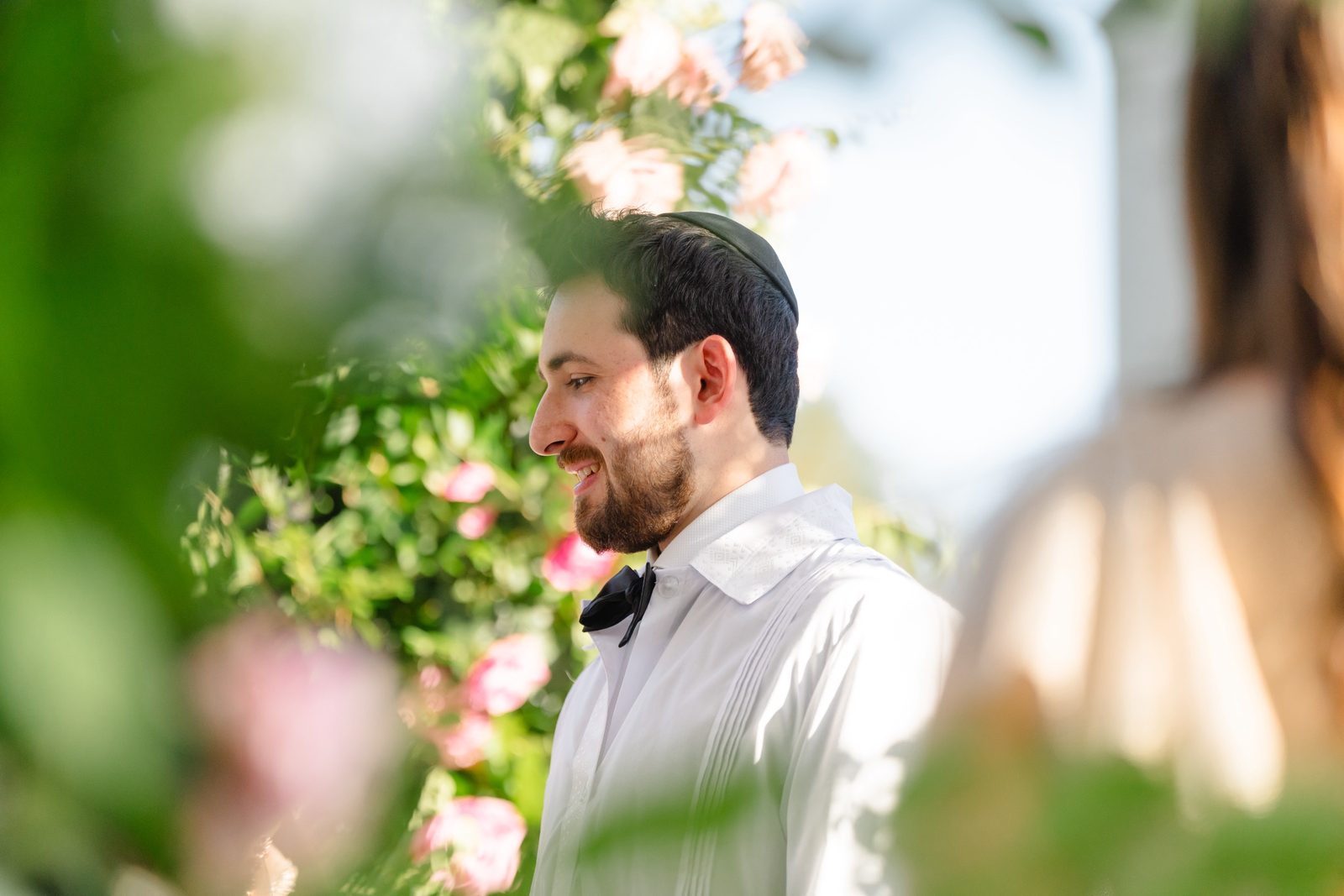 Haley and Evan under the floral chuppah