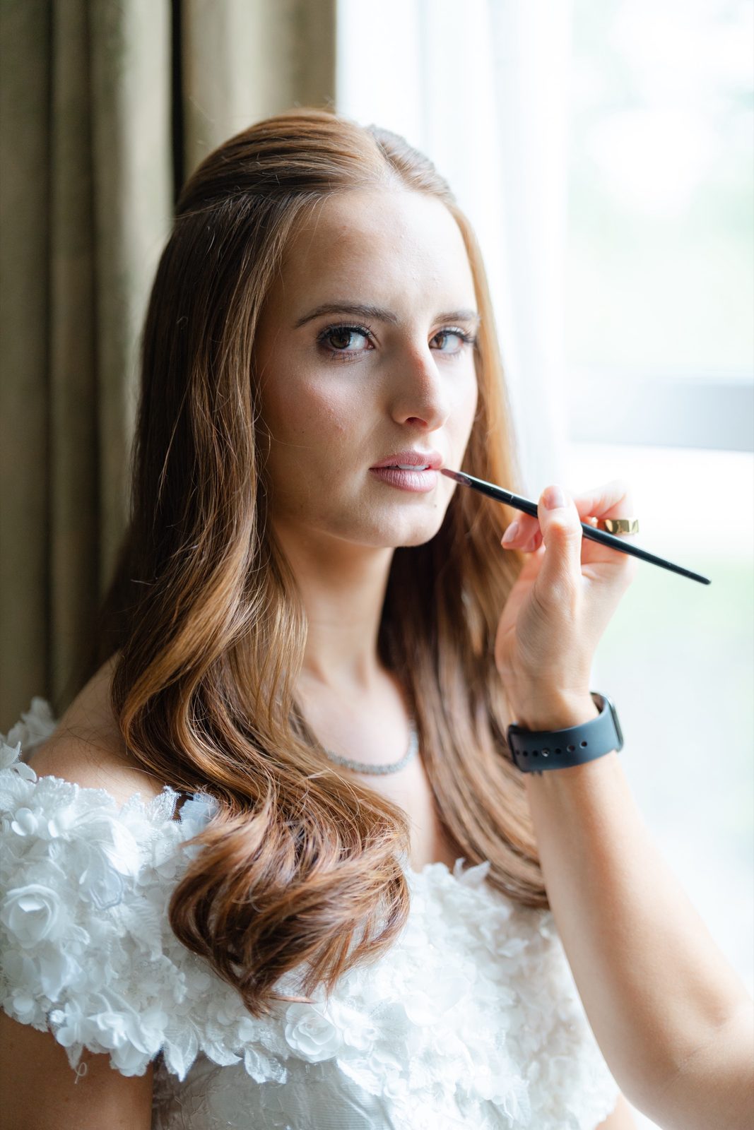 Olivia during makeup, looking up into the light