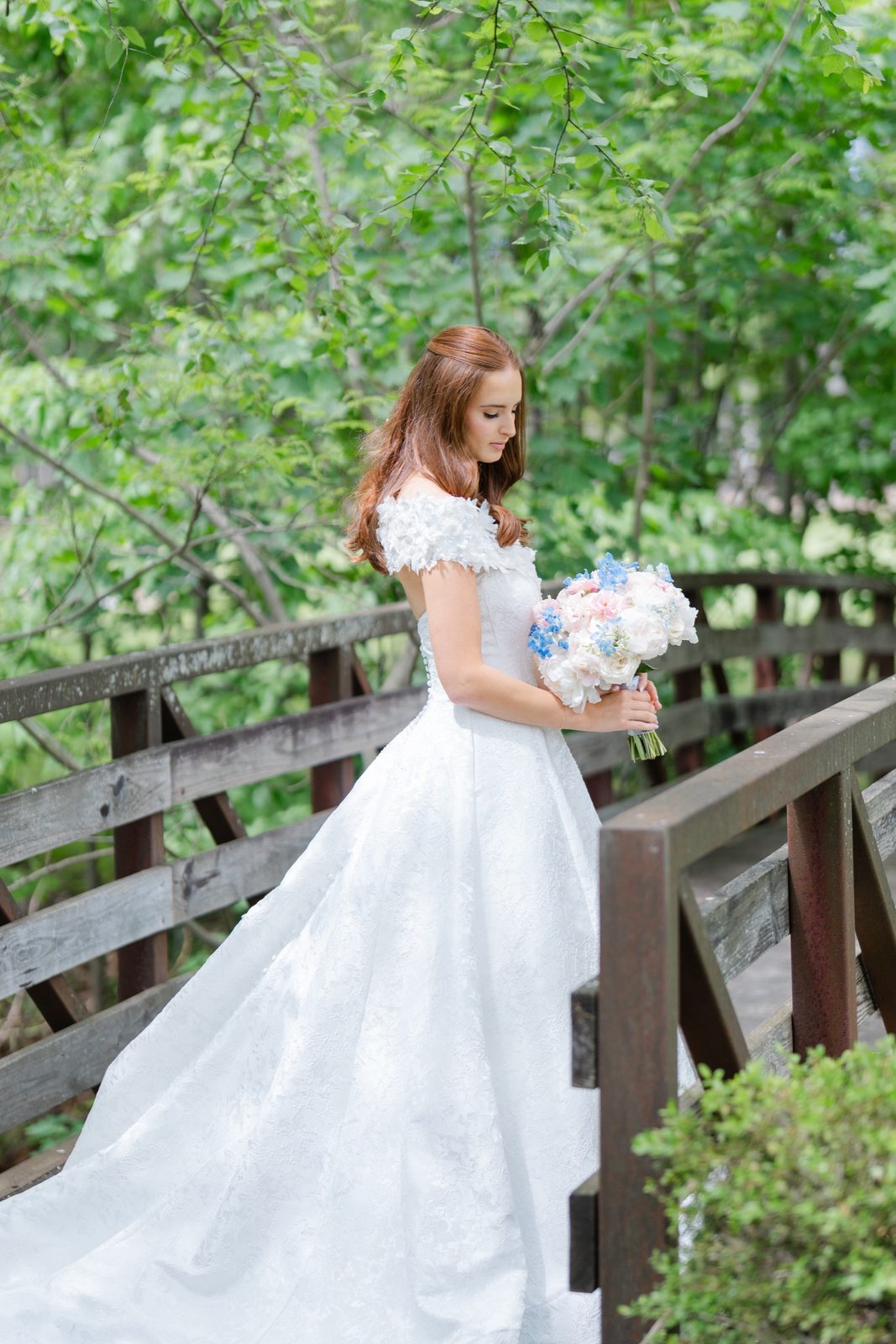 Olivia on the footbridge with her bouquet