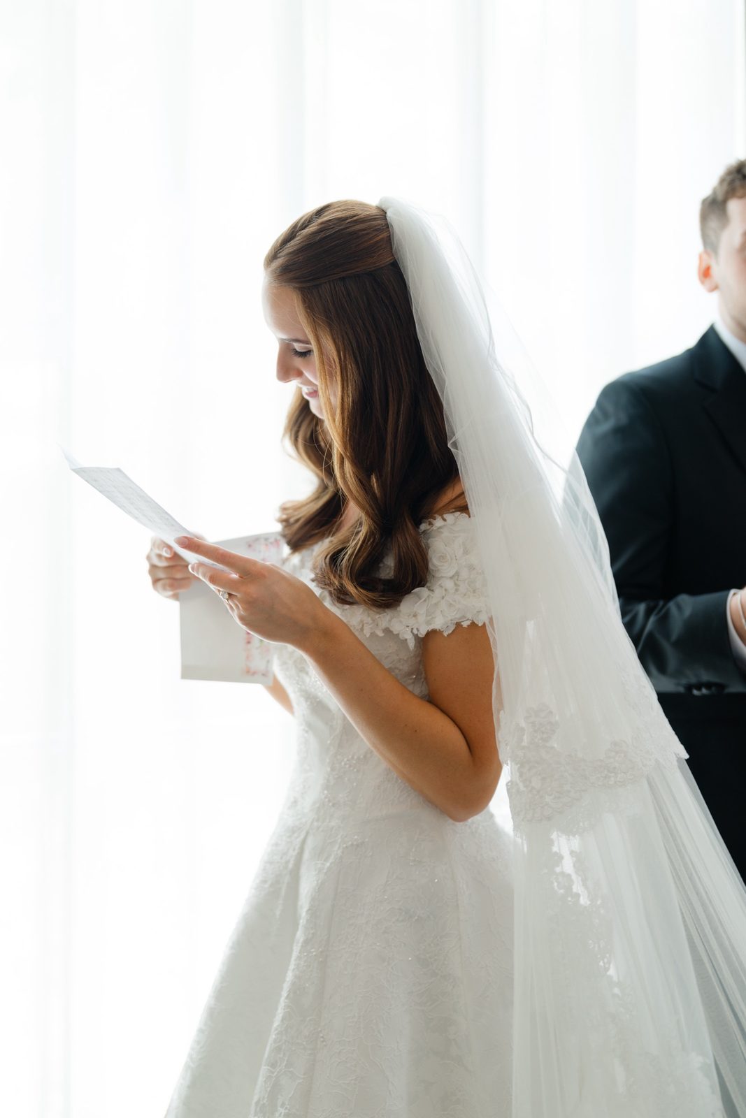 Olivia reading a letter before the ceremony