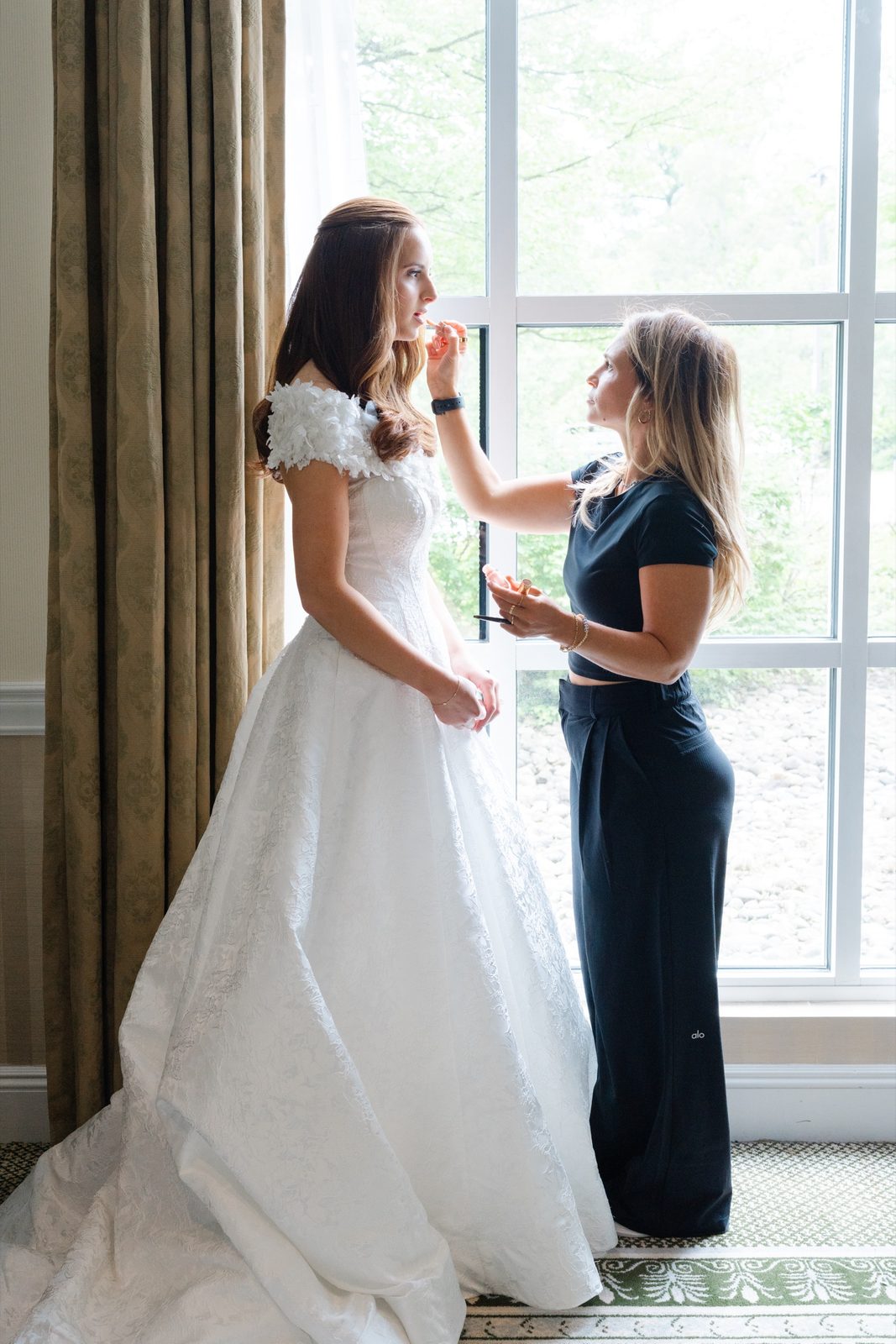 A last touch-up for Olivia by the window