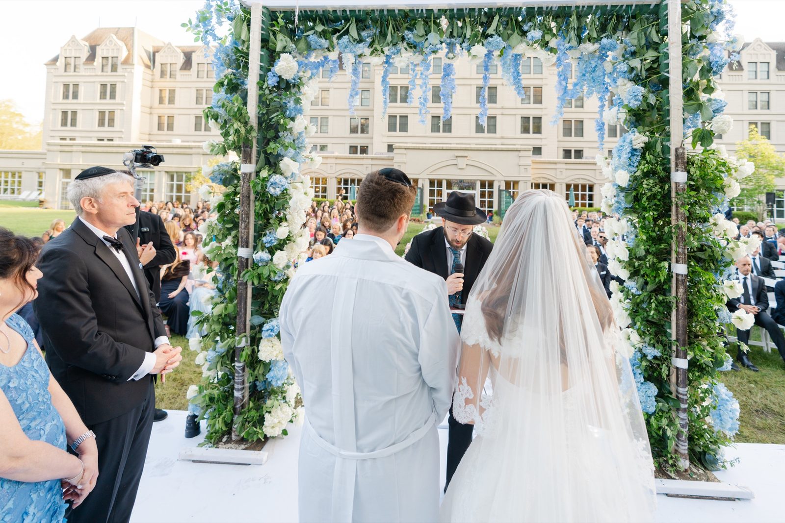 The chuppah on the lawn with the hotel behind it