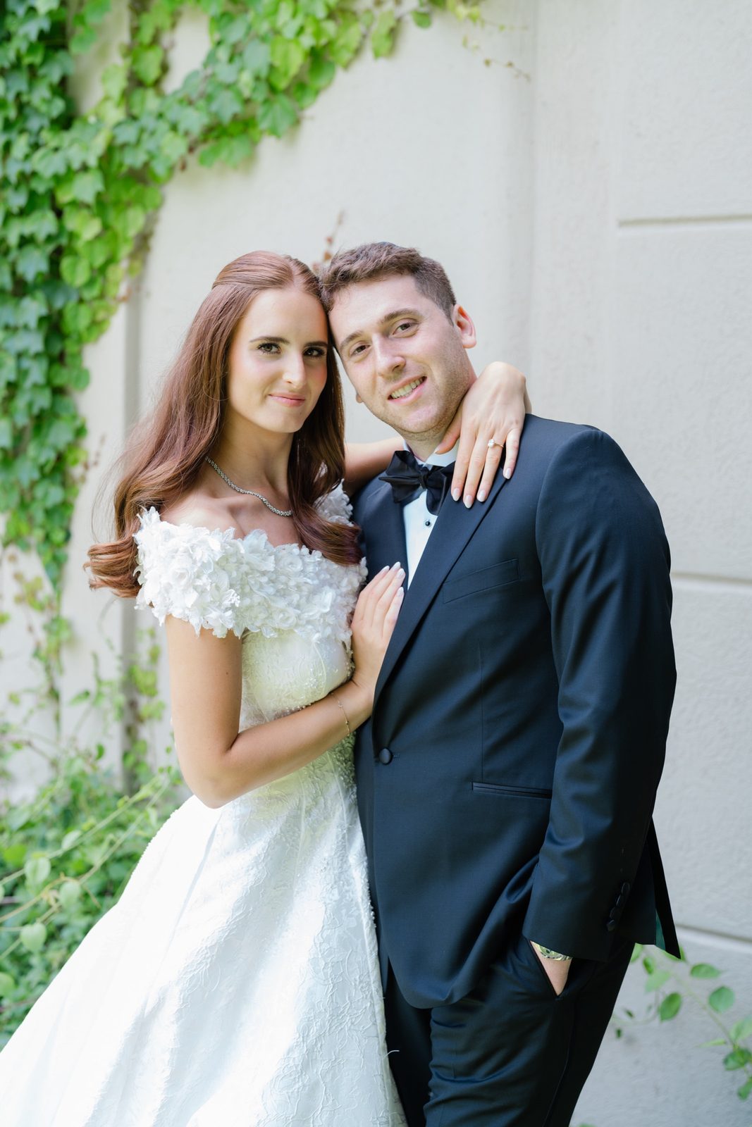 Olivia and Jeremy against the ivy-covered wall