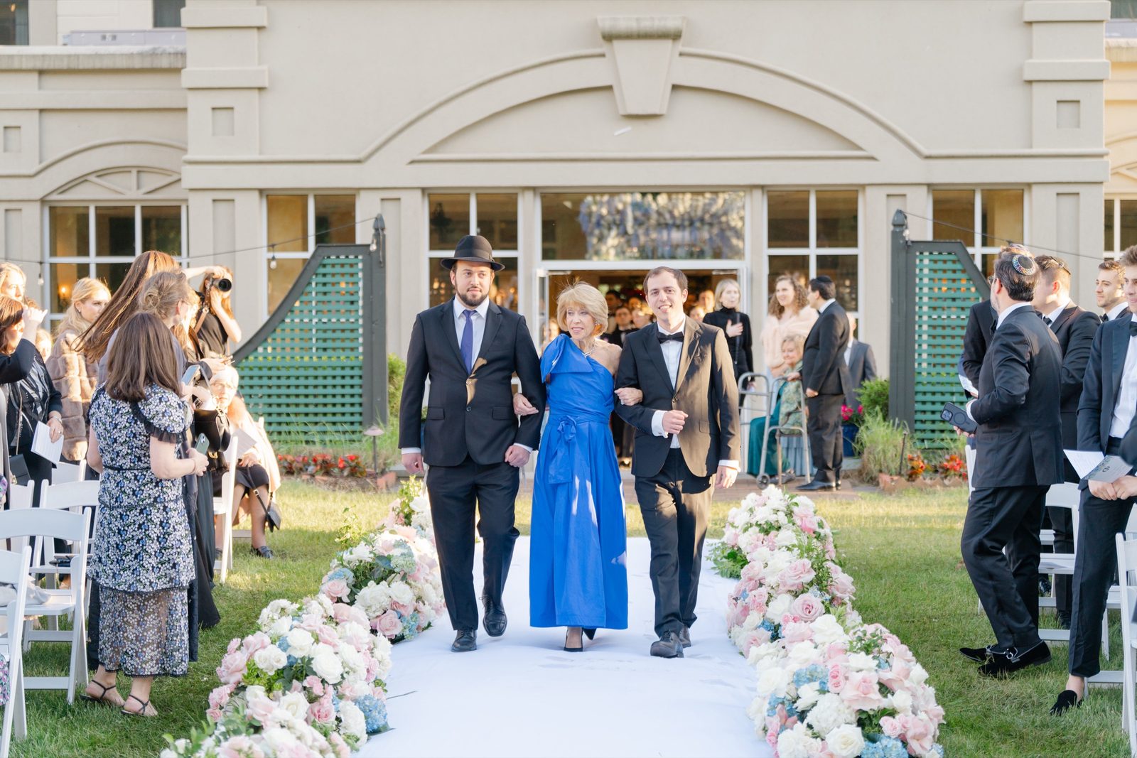 The processional coming out of the hotel onto the lawn