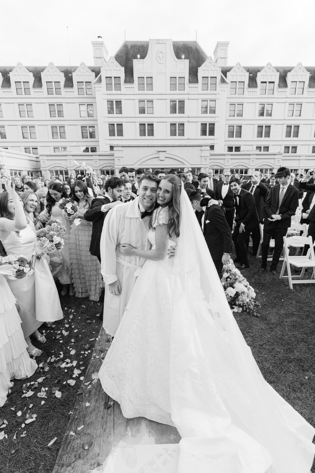 Black and white of the couple walking back up the aisle