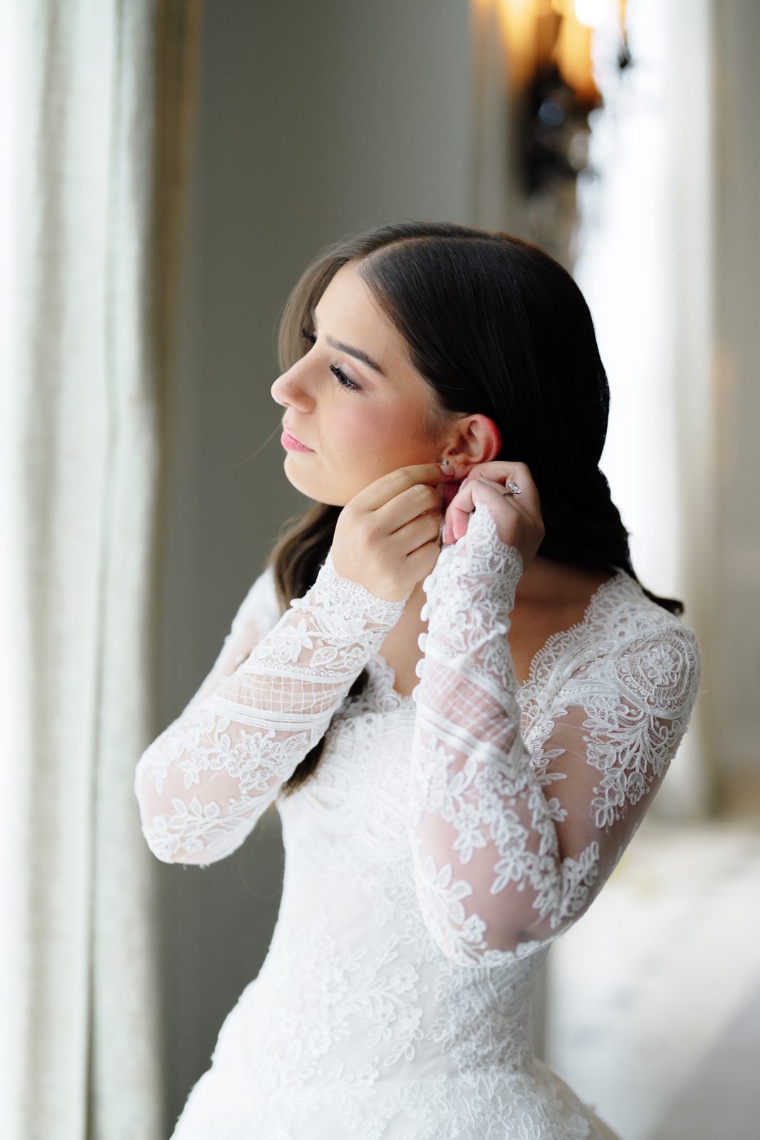 Tommi putting on her earrings