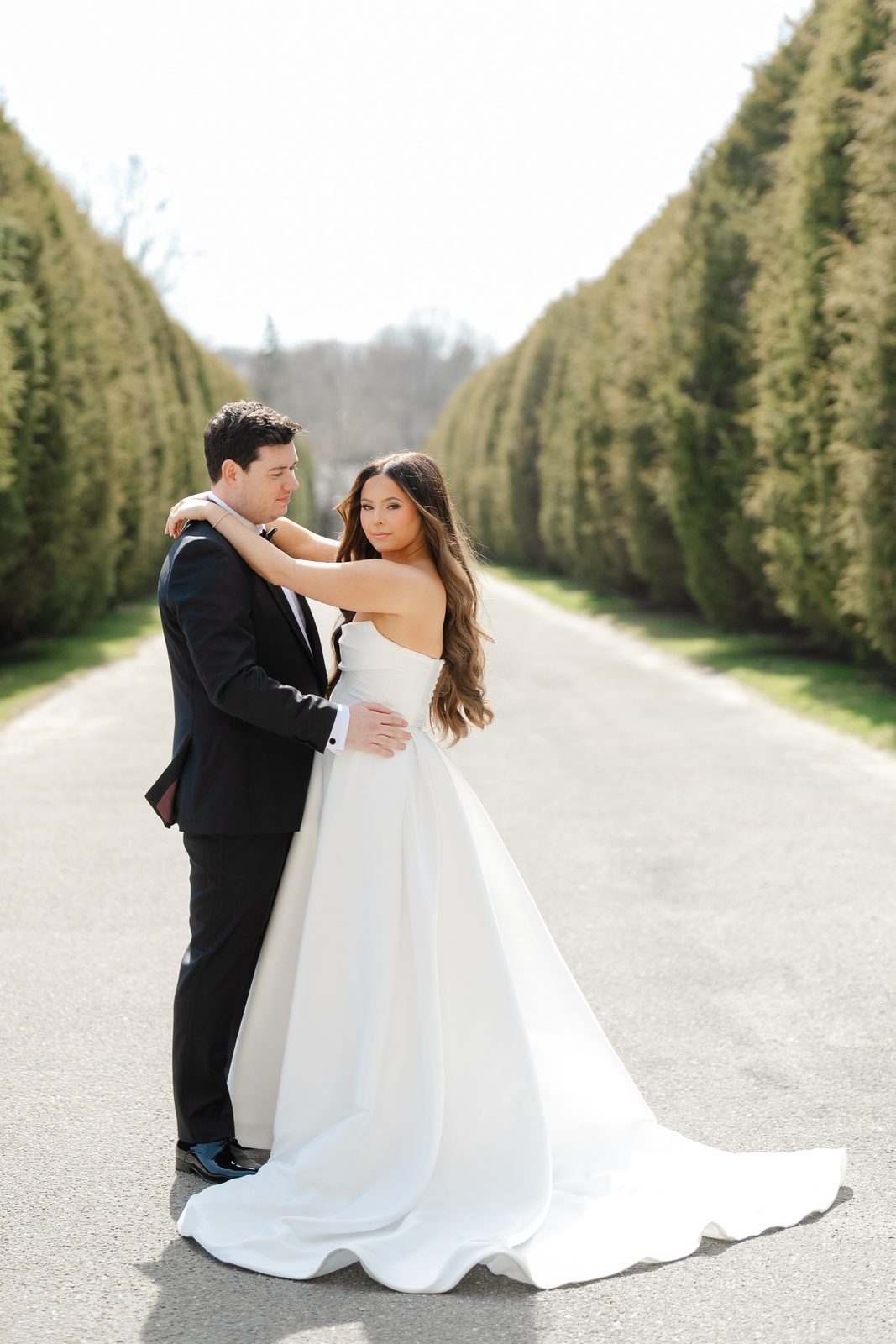 Rachel and Ian on the hedge-lined allée in the formal gardens at Oheka Castle