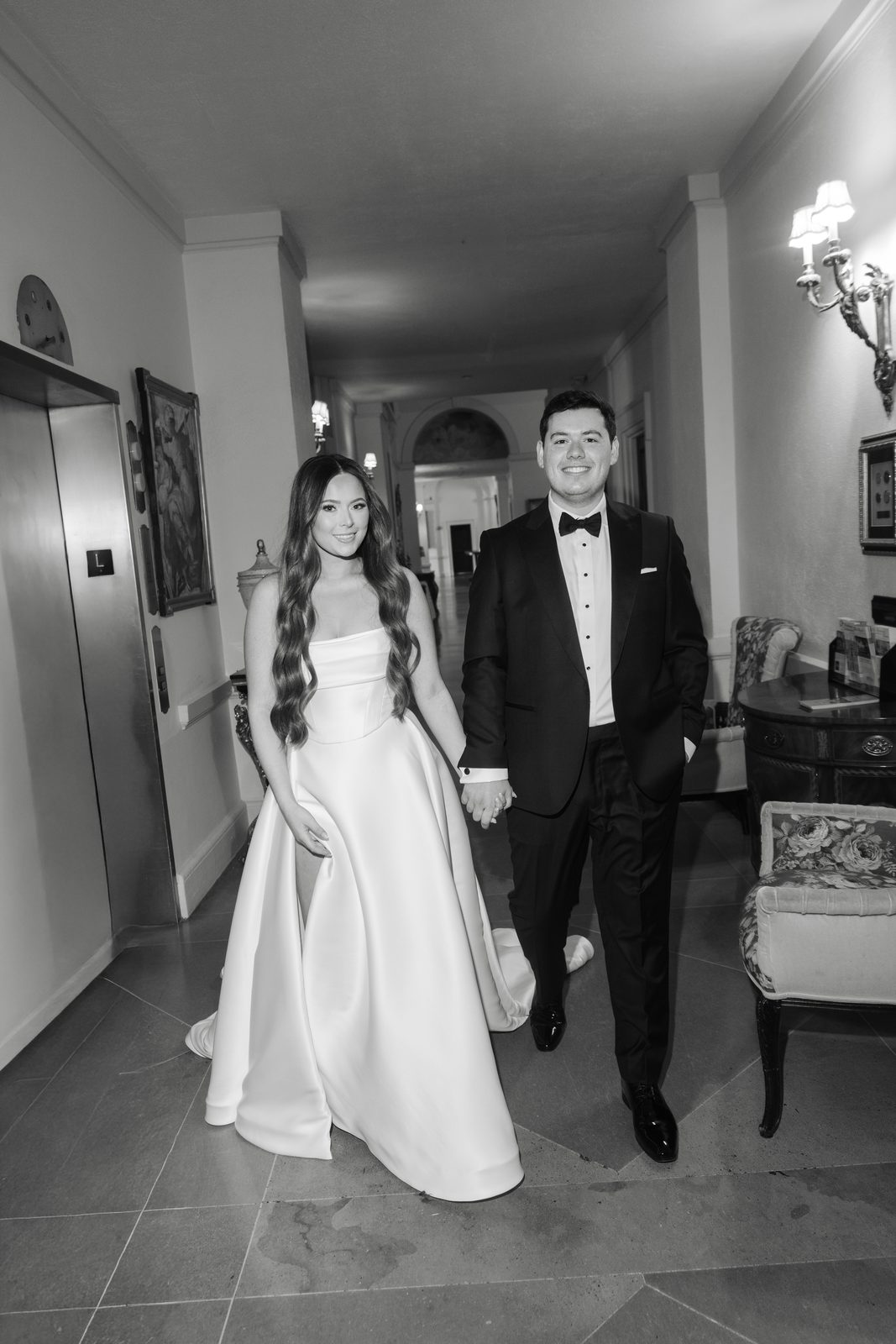 Rachel and Ian in a hallway at Oheka Castle, in black and white