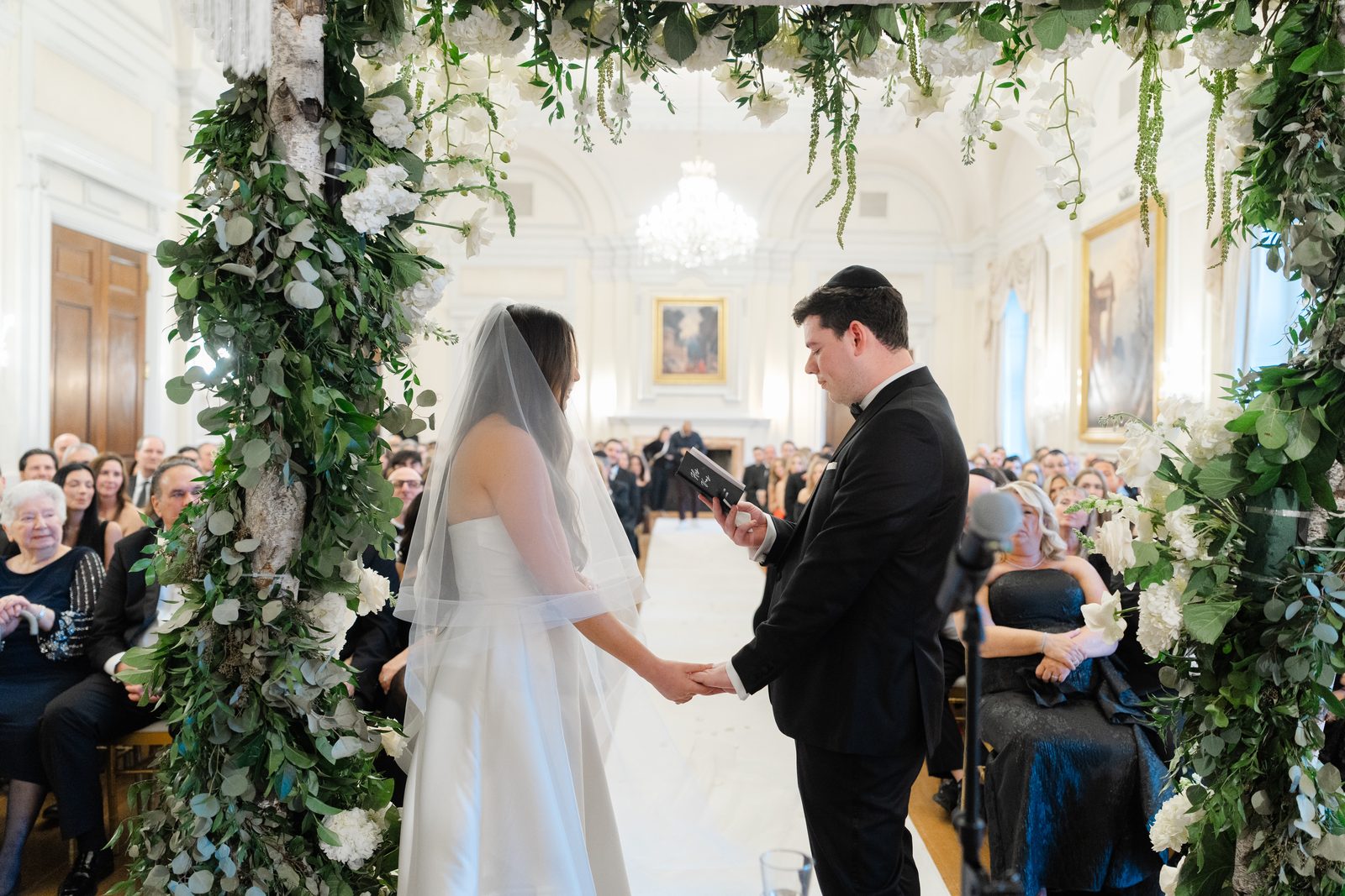 Rachel and Ian under the chuppah during their Jewish wedding ceremony at Oheka Castle