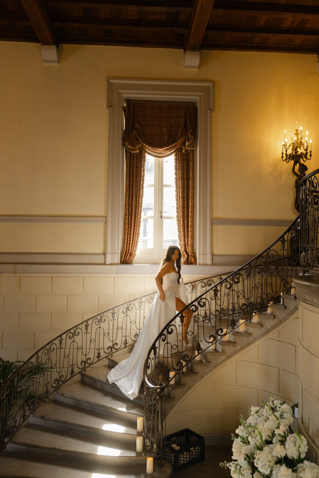 The candlelit grand staircase at Oheka Castle
