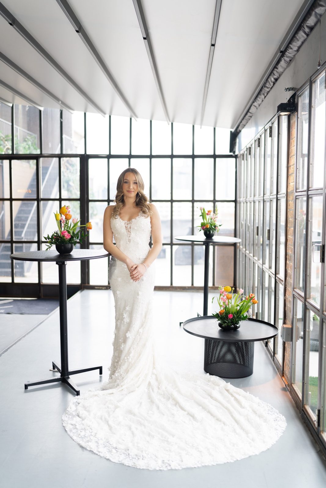 Amanda in a glass-walled room, her train spread across the floor
