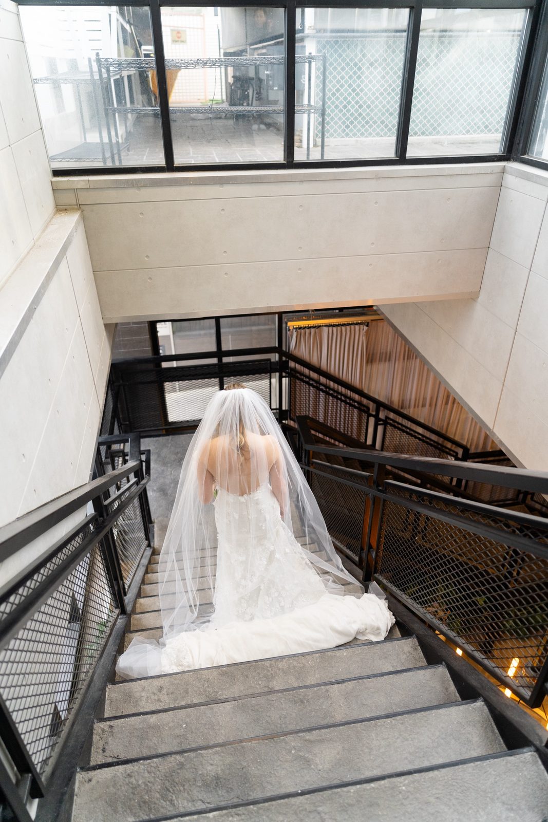 Amanda coming down the staircase to the ceremony