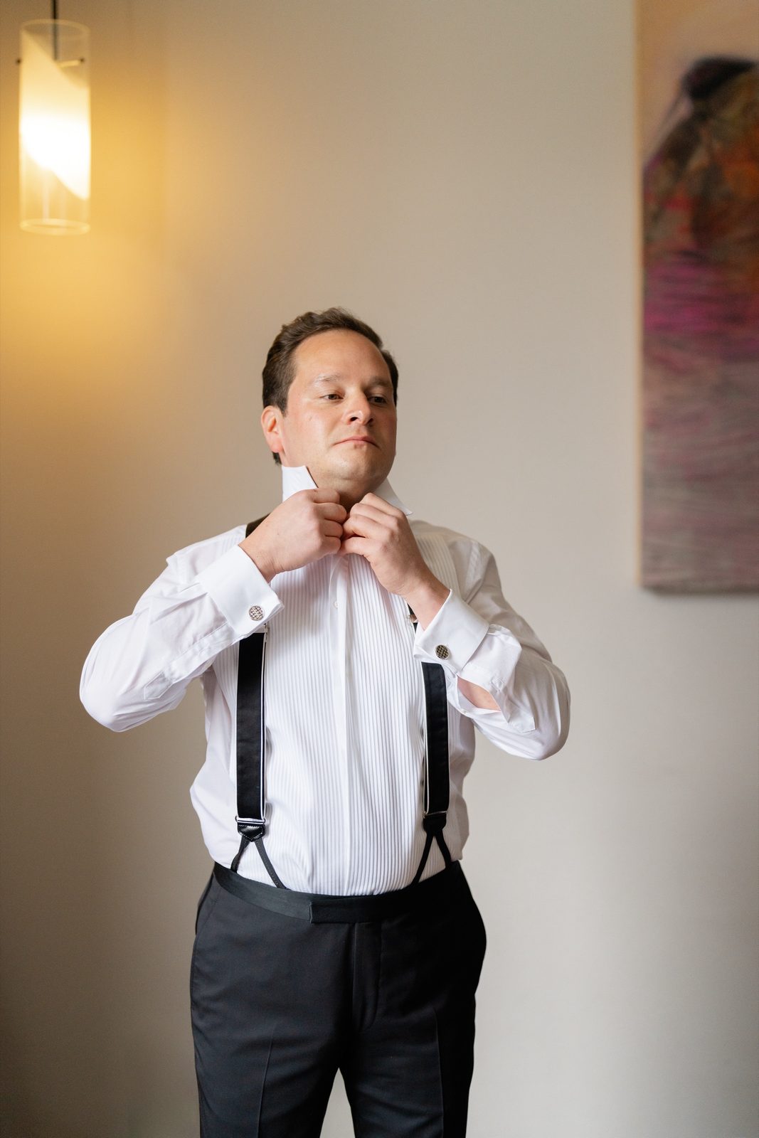 Greg buttoning his shirt