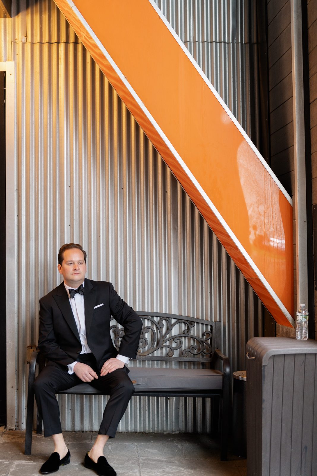 Greg seated by the orange staircase in the hotel
