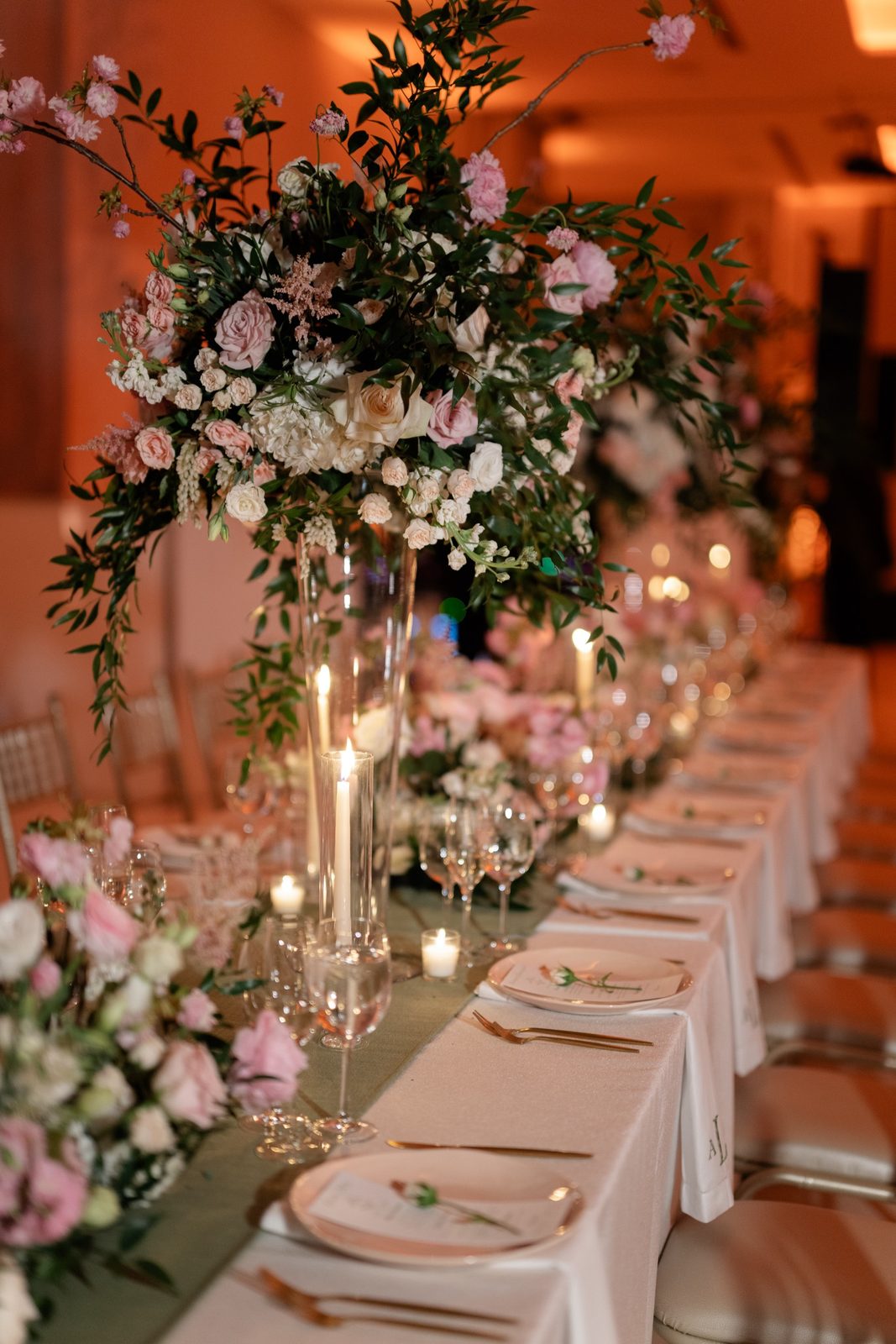A long table dressed in pink and white florals