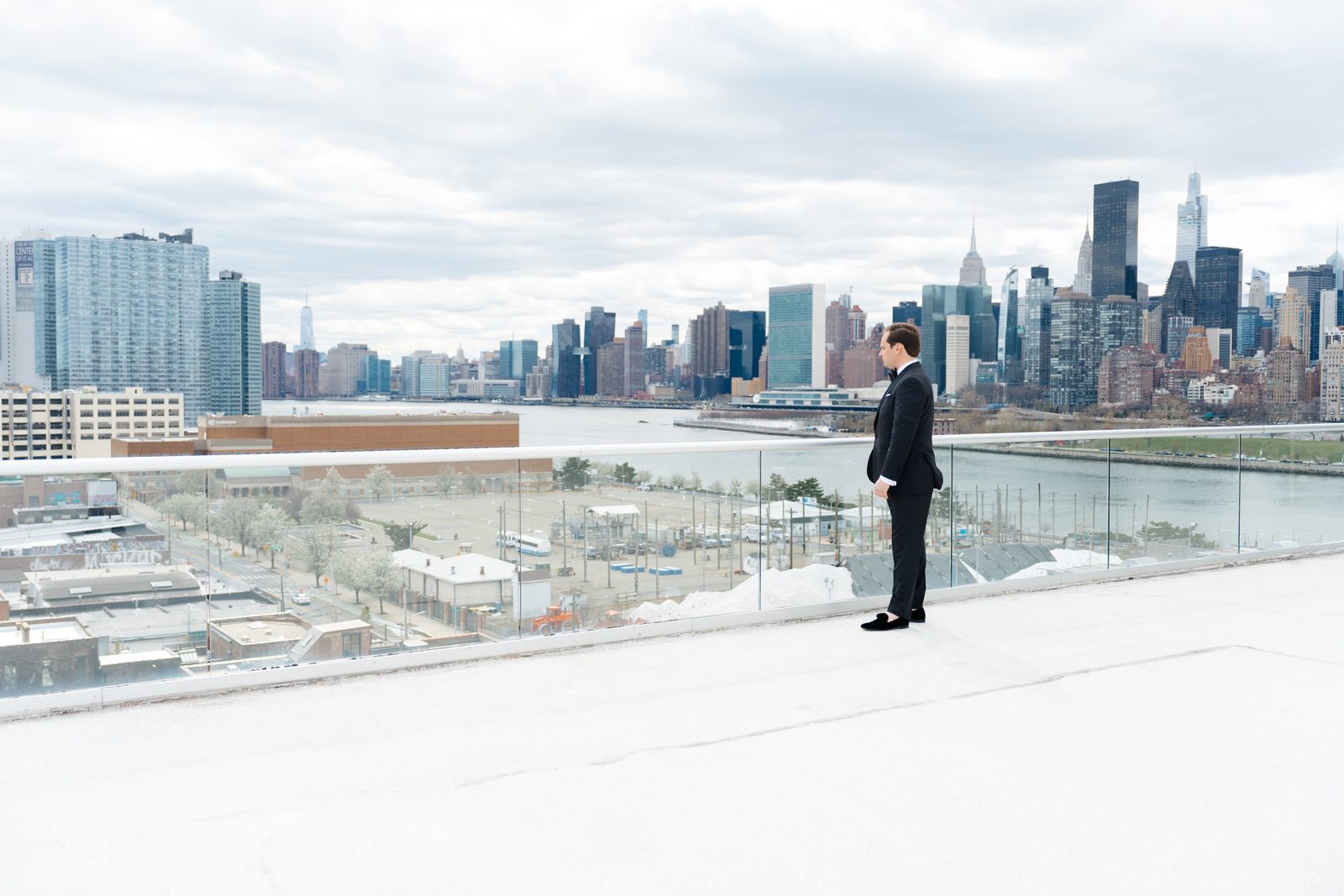 Greg waiting on the rooftop with the Manhattan skyline before the first look