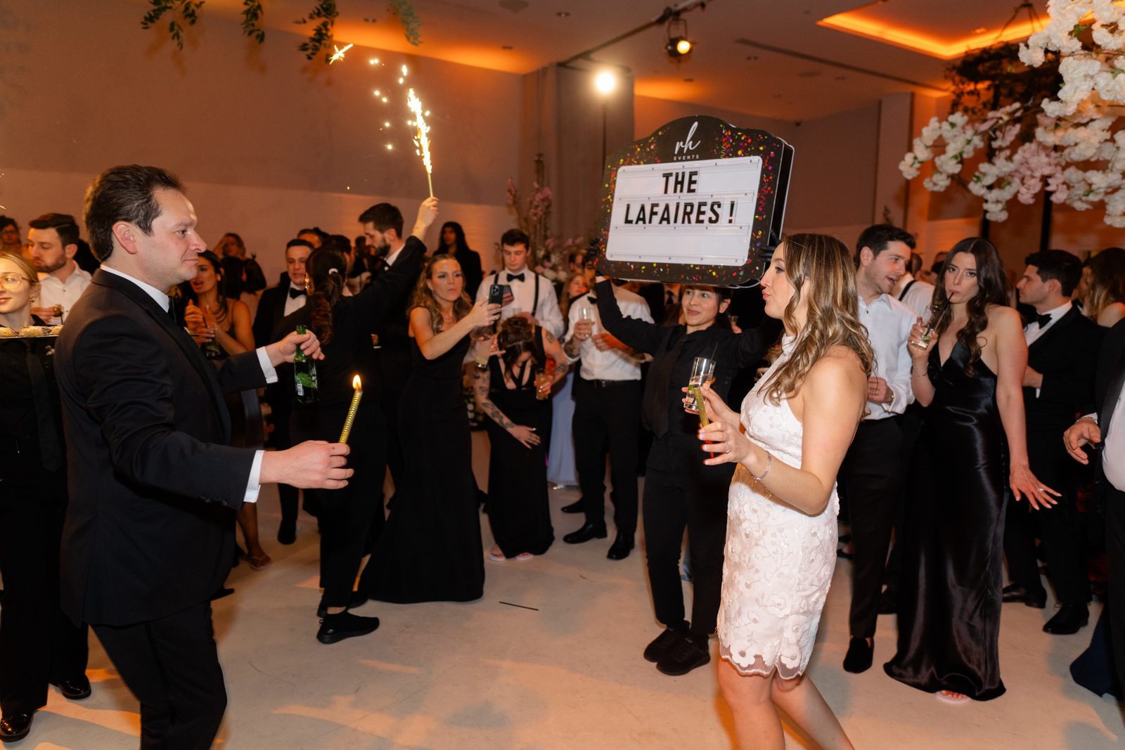 Guests holding up a sign that reads The Lafaires