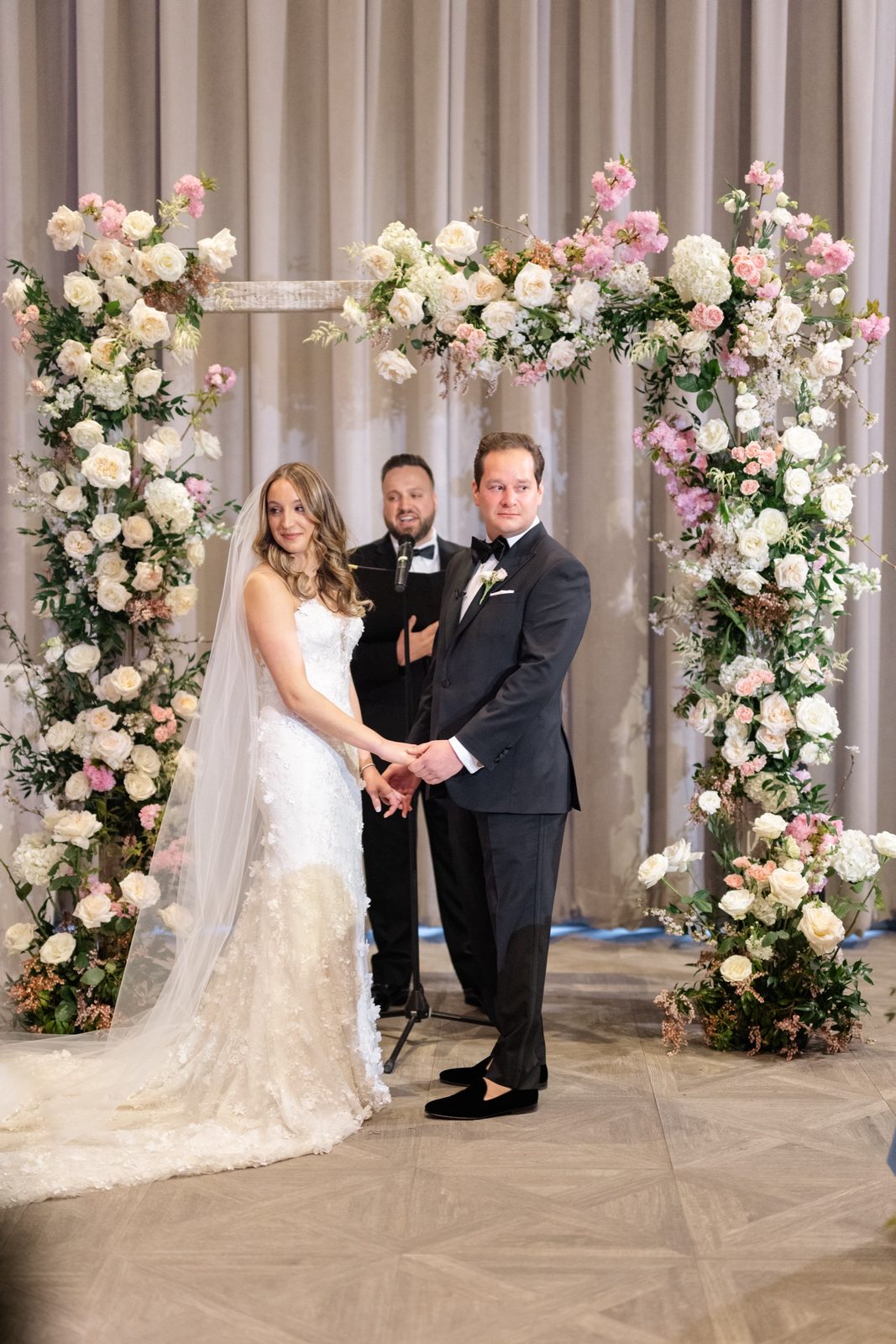 Amanda and Greg under the floral arch