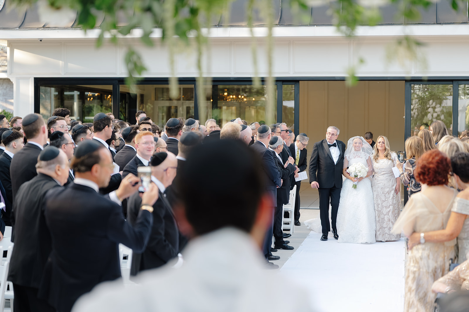 Rebecca and Phil’s outdoor wedding ceremony under a greenery-wrapped chuppah