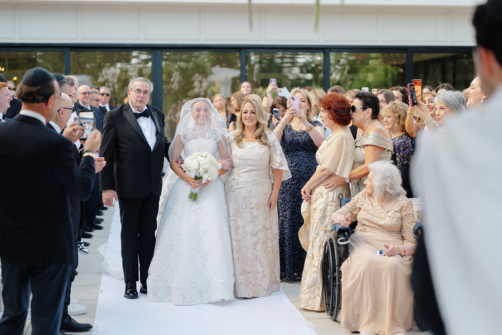 Rebecca and Phil’s outdoor wedding ceremony under a greenery-wrapped chuppah