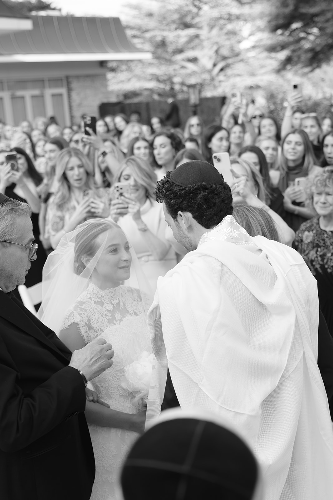 Rebecca and Phil’s outdoor wedding ceremony under a greenery-wrapped chuppah