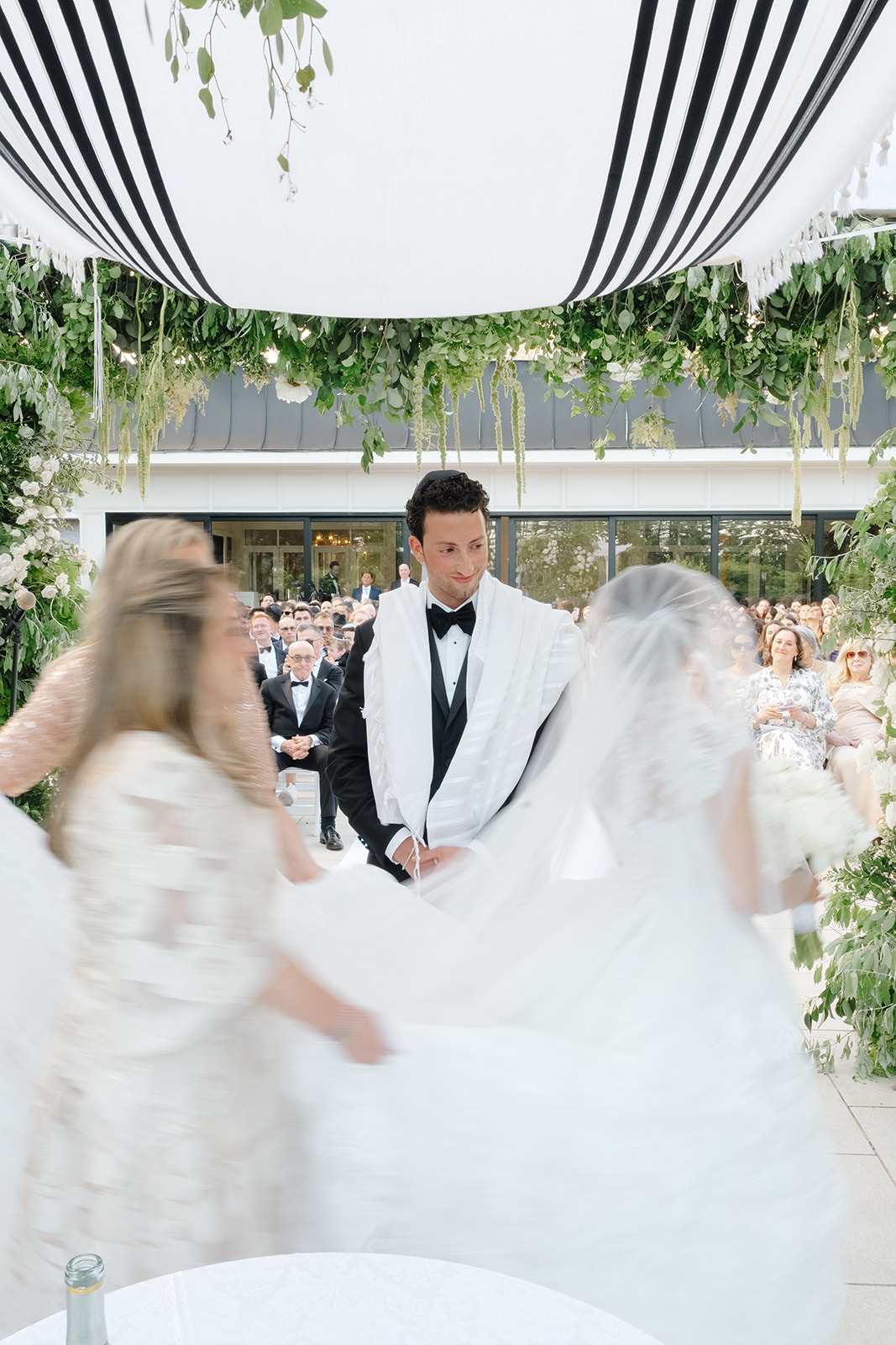 Rebecca and Phil’s outdoor wedding ceremony under a greenery-wrapped chuppah