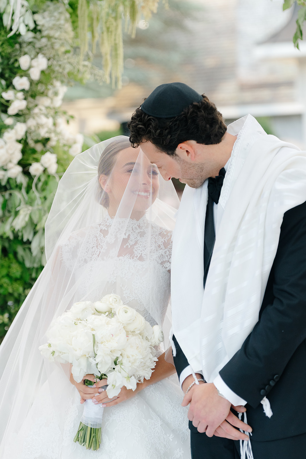 Rebecca and Phil’s outdoor wedding ceremony under a greenery-wrapped chuppah