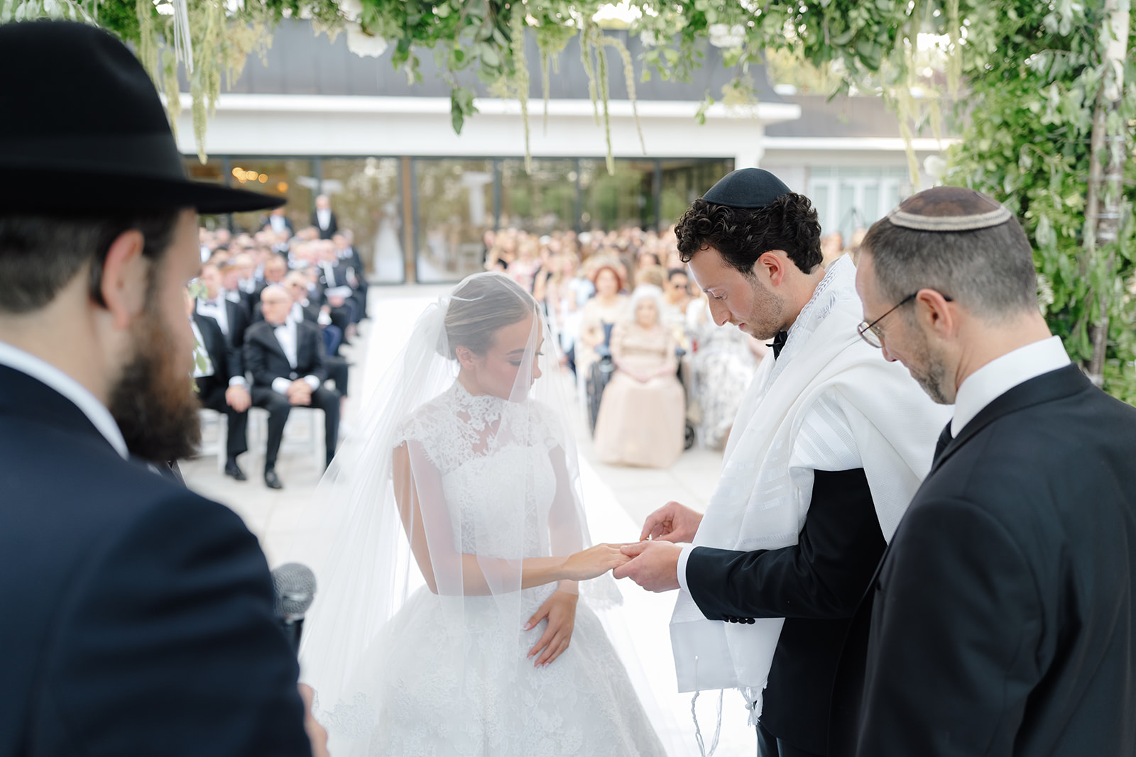 Rebecca and Phil’s outdoor wedding ceremony under a greenery-wrapped chuppah