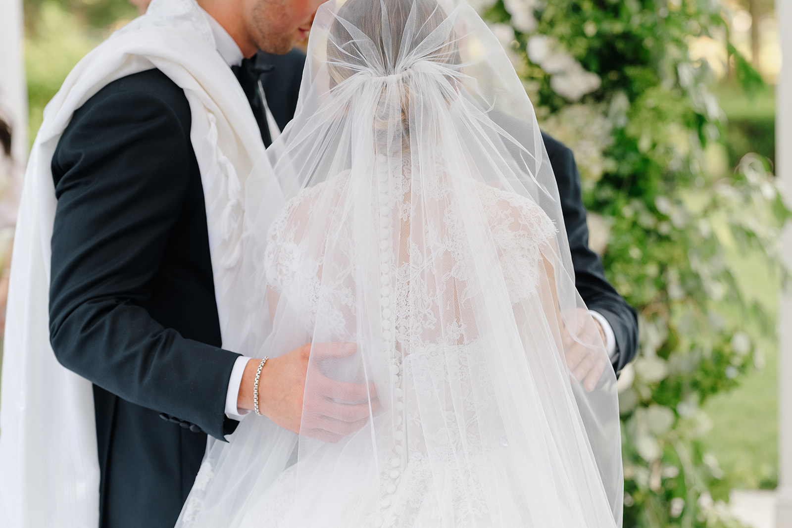 Rebecca and Phil’s outdoor wedding ceremony under a greenery-wrapped chuppah